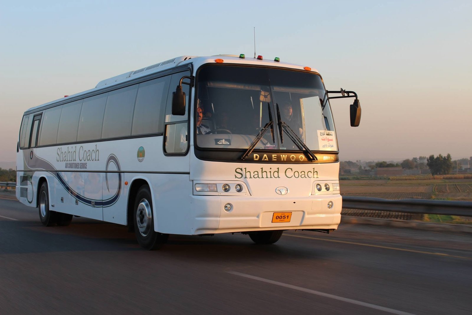 Shahid Coach AC bus travelling on the highway at sunrise